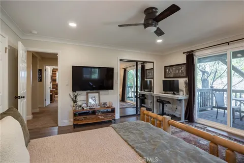 a bedroom with a large bed and a chandelier