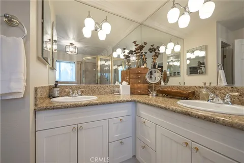 a spacious bedroom with two large bed and a flat screen tv