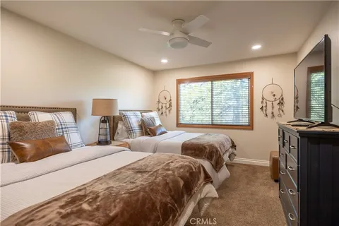 a room with pool table and windows