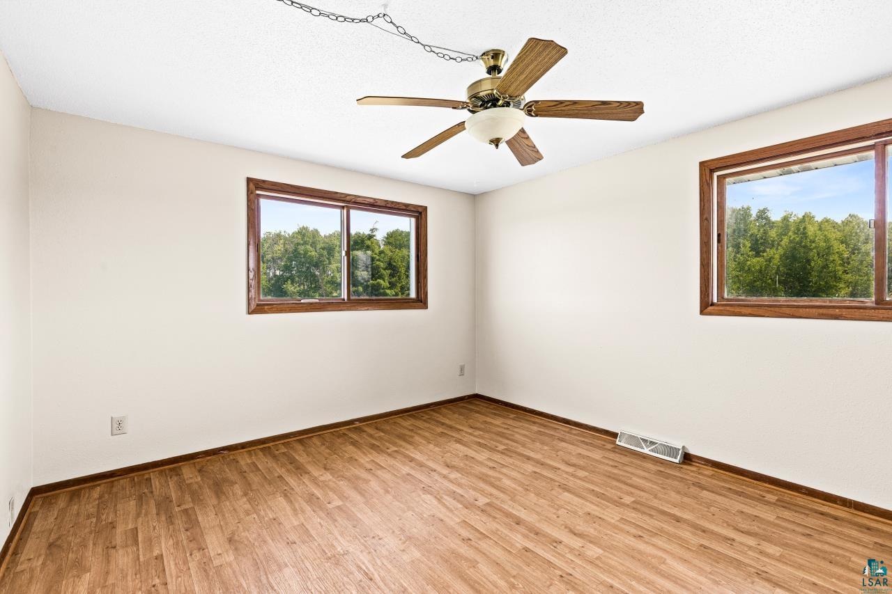 6606 Metso Road Kettle River, MN 55757 - Photo 17 of 84 Bright interior space featuring wood-finish flooring and two distinct windows with wooden frames