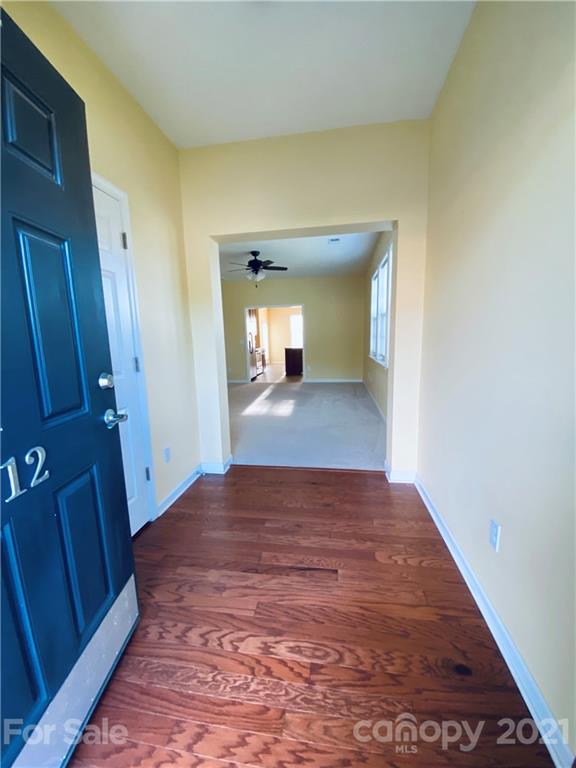 12 South River Road Fletcher, NC 28732 - Photo 2 of 21 a view of a hallway with wooden floor and a bathroom