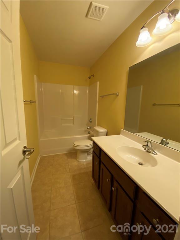 12 South River Road Fletcher, NC 28732 - Photo 18 of 21 a bathroom with a sink mirror and a shower