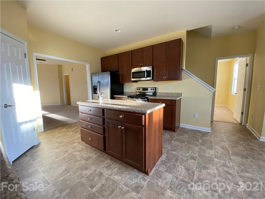 12 South River Road Fletcher, NC 28732 - Photo 9 of 21 a kitchen with a stove sink and a refrigerator