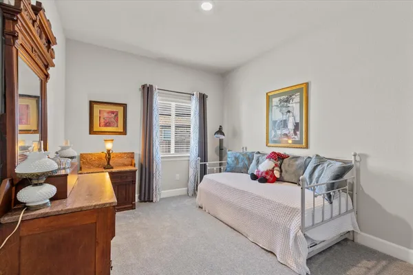 a bedroom with furniture and a potted plant