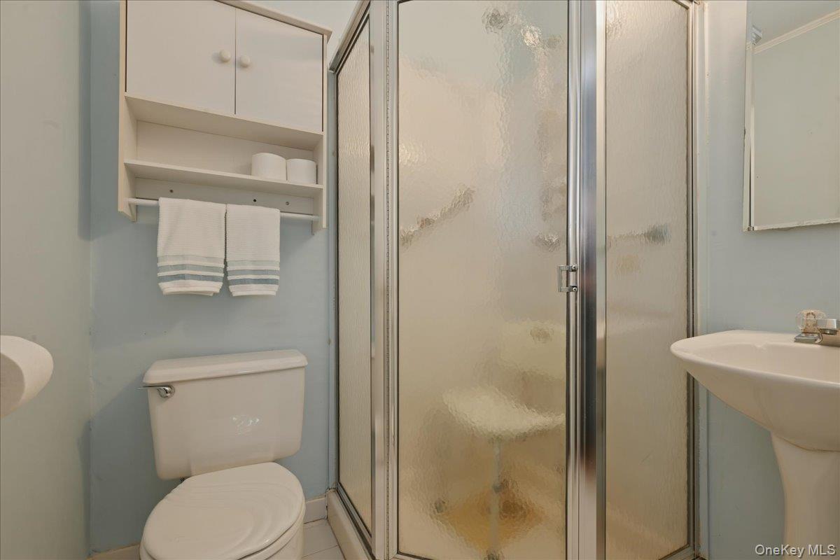 17 Avon Road Farmingdale, NY 11735 - Photo 19 of 46 a white toilet sitting next to a bathroom sink