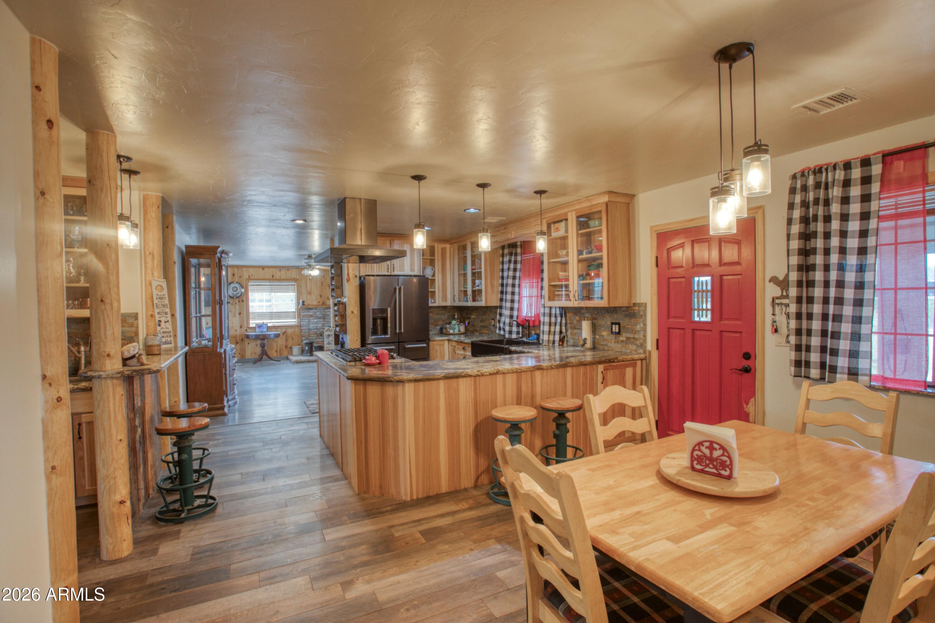 5 Co Road Show Low, AZ 85901 - Photo 7 of 39 a view of a dining room and livingroom with furniture wooden floor a chandelier