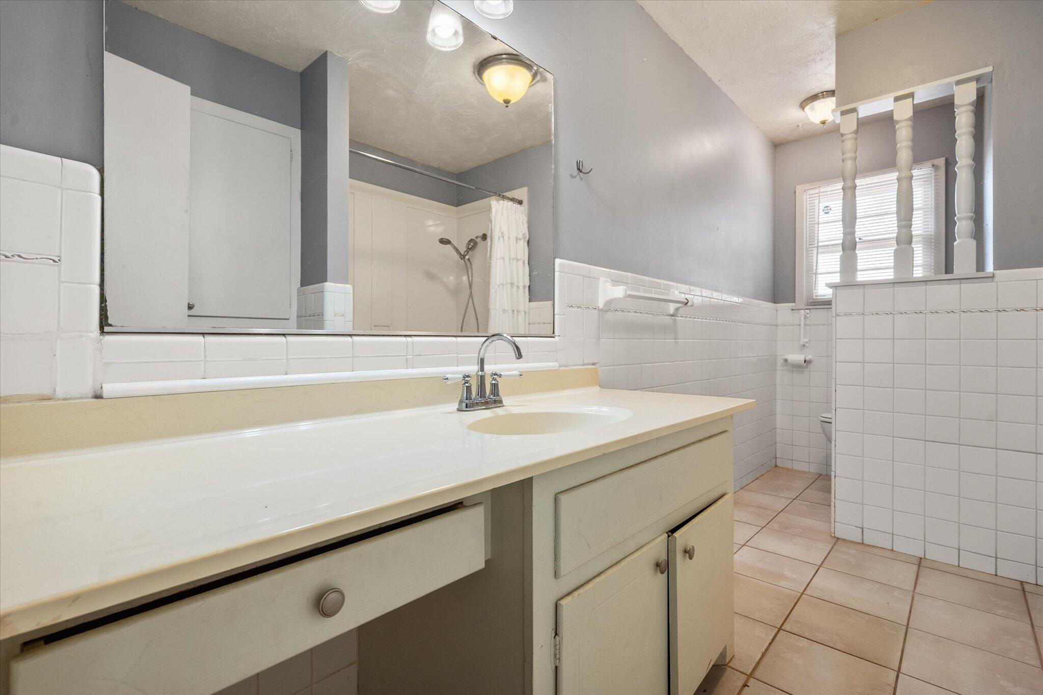 4604 27th Street Lubbock, TX 79410 - Photo 9 of 36 a bathroom with a sink and a mirror