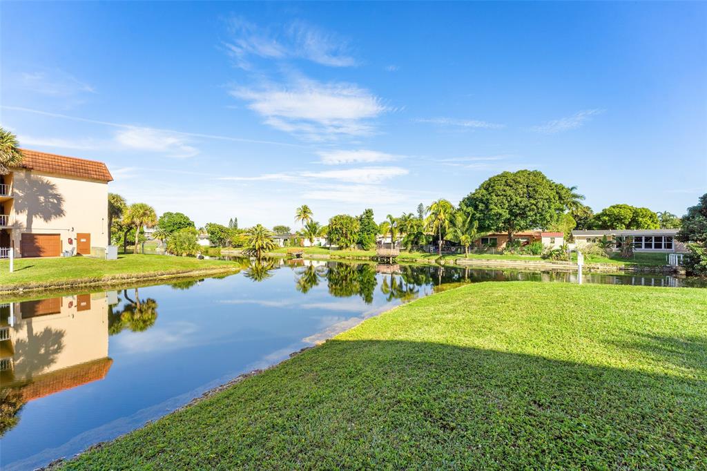 2720 North Pine Island Road, Unit 212 Sunrise, FL 33322 - Photo 17 of 49 LAKE TO REAR OF BUILDING