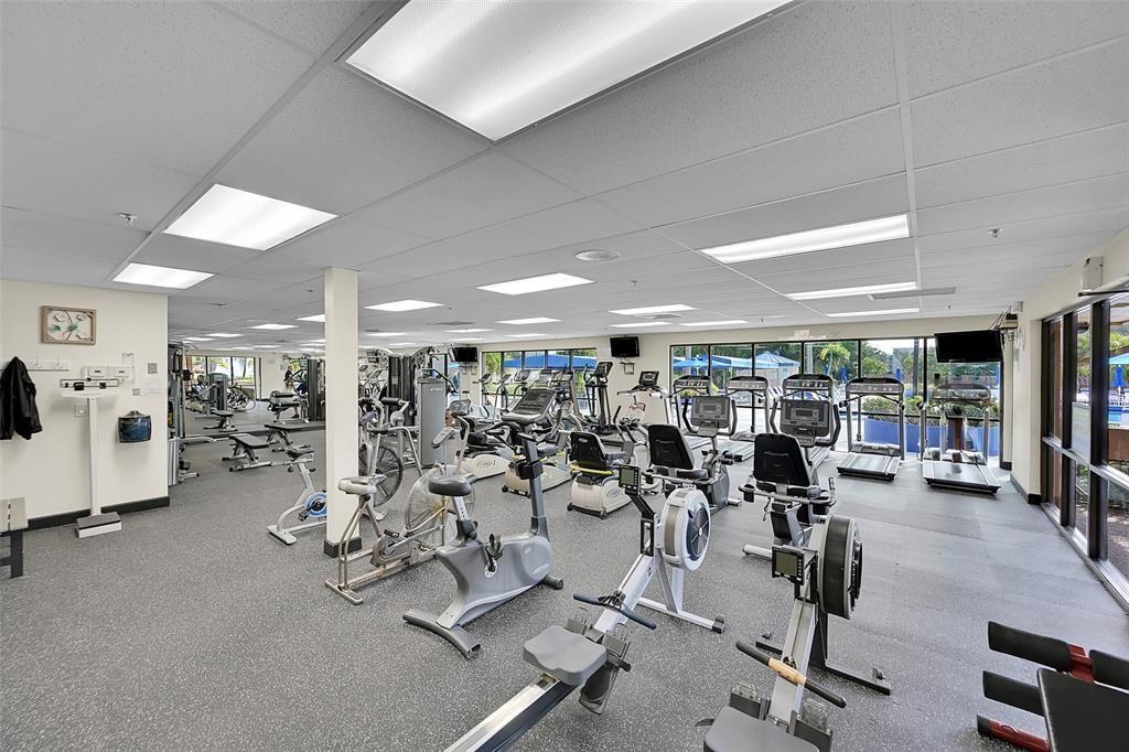 2720 North Pine Island Road, Unit 212 Sunrise, FL 33322 - Photo 30 of 49 a room with gym equipment and large mirror