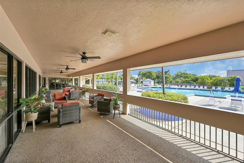 2720 North Pine Island Road, Unit 212 Sunrise, FL 33322 - Photo 33 of 49 a living room with furniture floor to ceiling window and an outdoor view