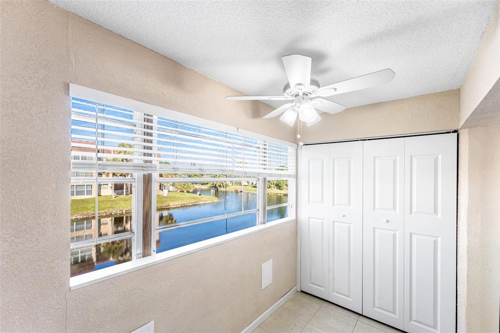 2720 North Pine Island Road, Unit 212 Sunrise, FL 33322 - Photo 9 of 49 a view of an entryway with a chandelier fan