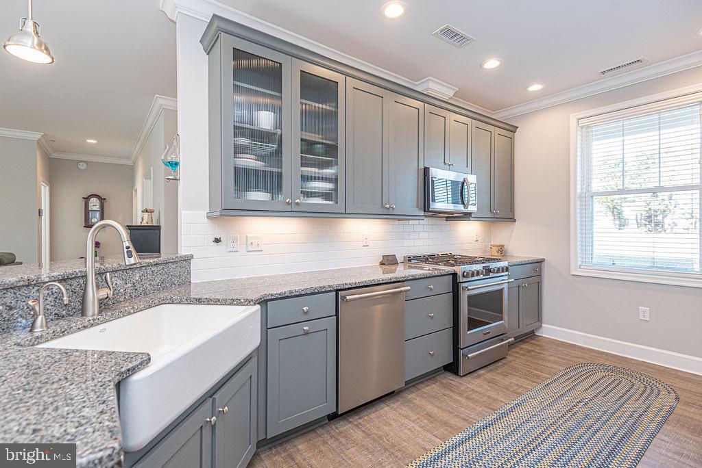 11910 Back Creek Road Bishopville, MD 21813 - Photo 14 of 94 a kitchen with stainless steel appliances granite countertop a sink stove and cabinets