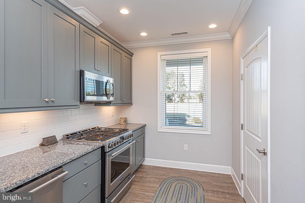 11910 Back Creek Road Bishopville, MD 21813 - Photo 15 of 94 a kitchen with granite countertop cabinets stainless steel appliances a sink and a window