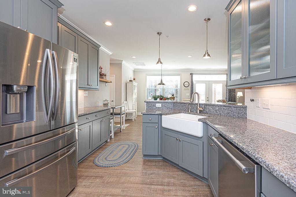 11910 Back Creek Road Bishopville, MD 21813 - Photo 17 of 94 a kitchen with stainless steel appliances granite countertop a sink refrigerator and cabinets