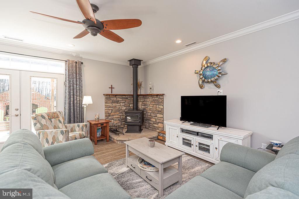 11910 Back Creek Road Bishopville, MD 21813 - Photo 19 of 94 a living room with furniture a flat screen tv and a large window