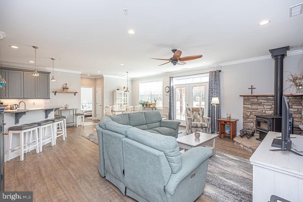 11910 Back Creek Road Bishopville, MD 21813 - Photo 20 of 94 a living room with fireplace furniture and a wooden floor