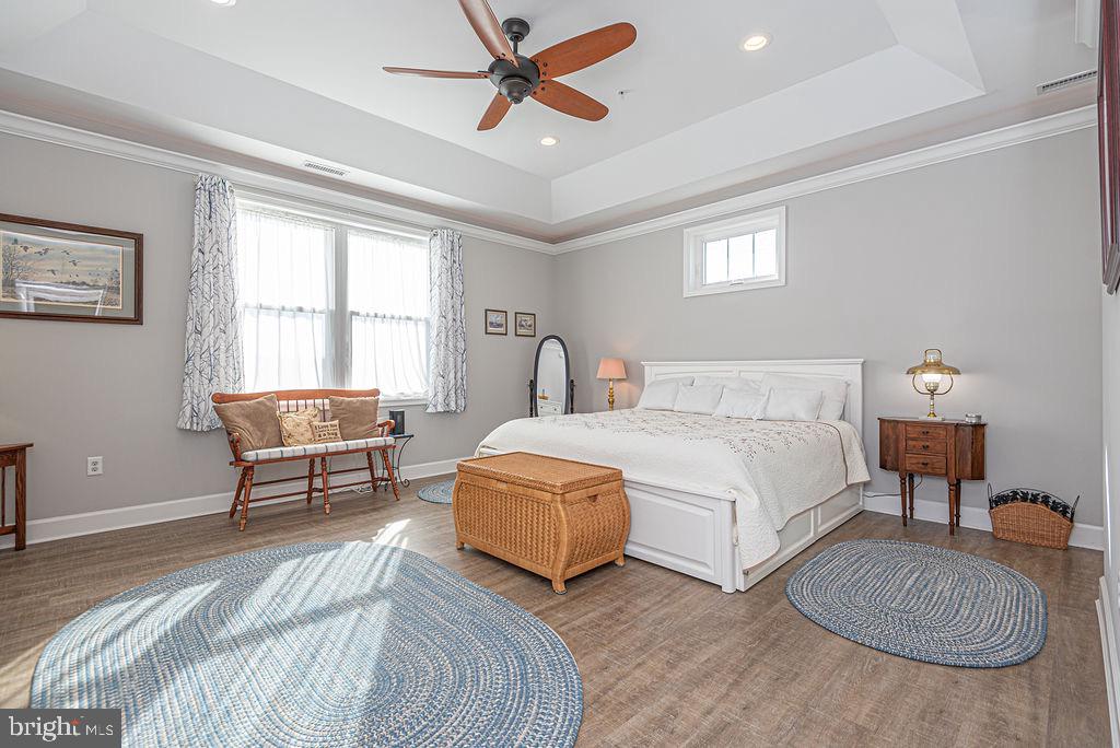 11910 Back Creek Road Bishopville, MD 21813 - Photo 23 of 94 a bedroom with a bed a couch and a dresser next to a window