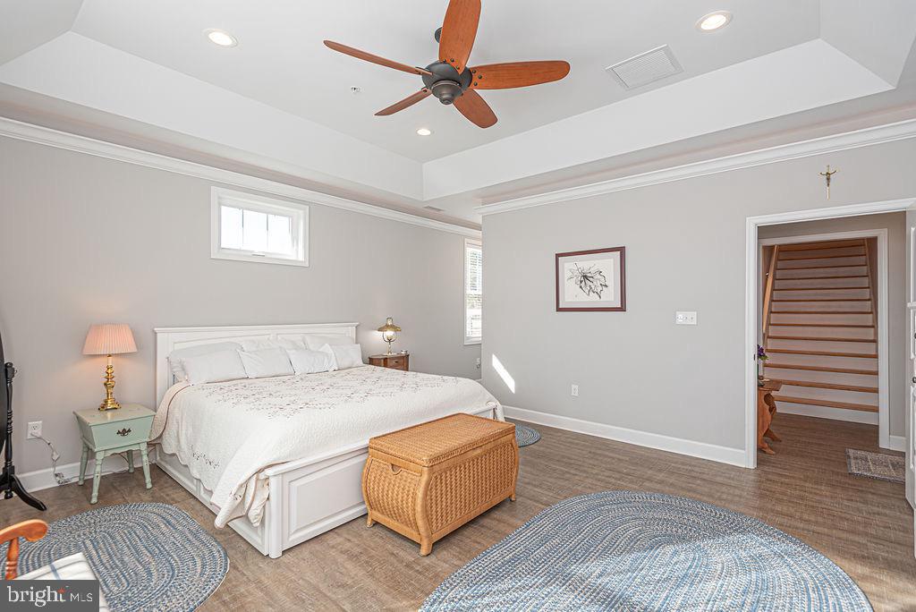 11910 Back Creek Road Bishopville, MD 21813 - Photo 24 of 94 a bedroom with a bed and a chandelier