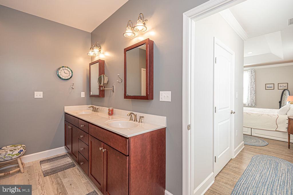 11910 Back Creek Road Bishopville, MD 21813 - Photo 29 of 94 a spacious bathroom with a double vanity sink mirror and