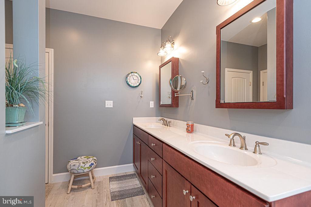 11910 Back Creek Road Bishopville, MD 21813 - Photo 30 of 94 a bathroom with a double vanity sink and a mirror