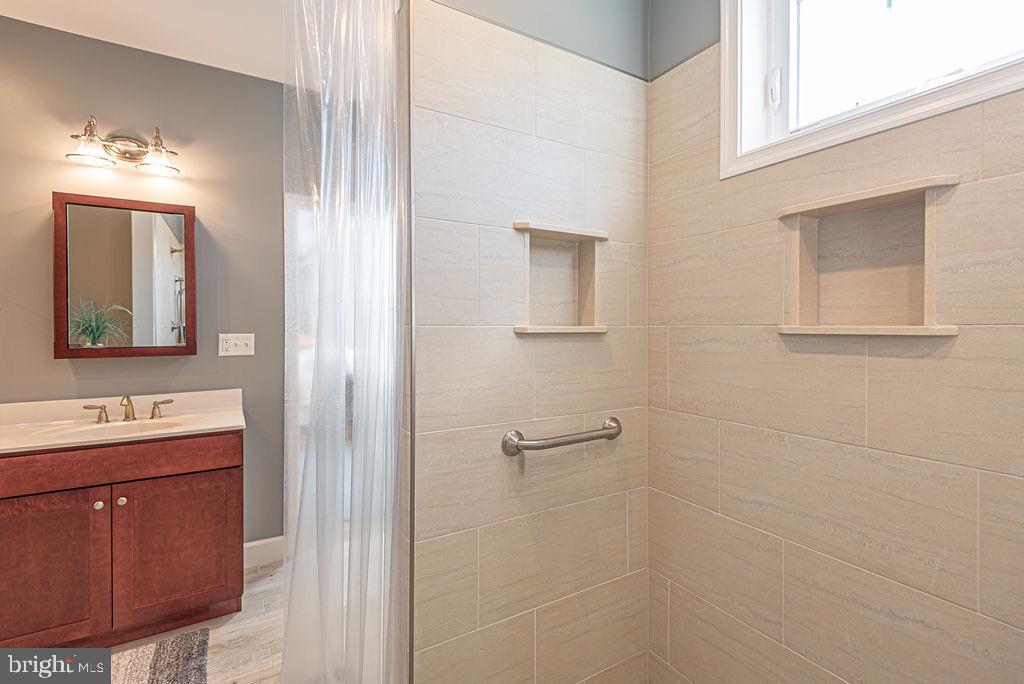 11910 Back Creek Road Bishopville, MD 21813 - Photo 32 of 94 a bathroom with a sink a toilet and mirror