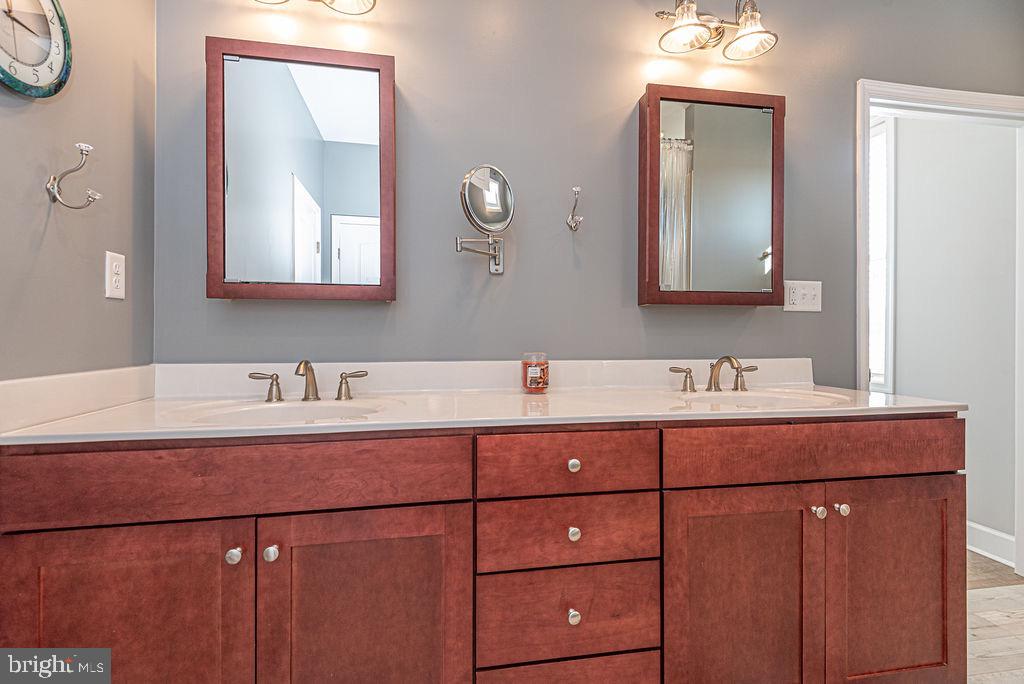 11910 Back Creek Road Bishopville, MD 21813 - Photo 35 of 94 a bathroom with a sink and a mirror