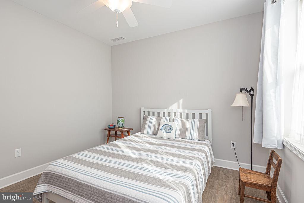 11910 Back Creek Road Bishopville, MD 21813 - Photo 38 of 94 a bedroom with a bed and a chair