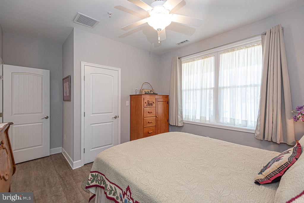 11910 Back Creek Road Bishopville, MD 21813 - Photo 44 of 94 a bedroom with a bed and a chandelier