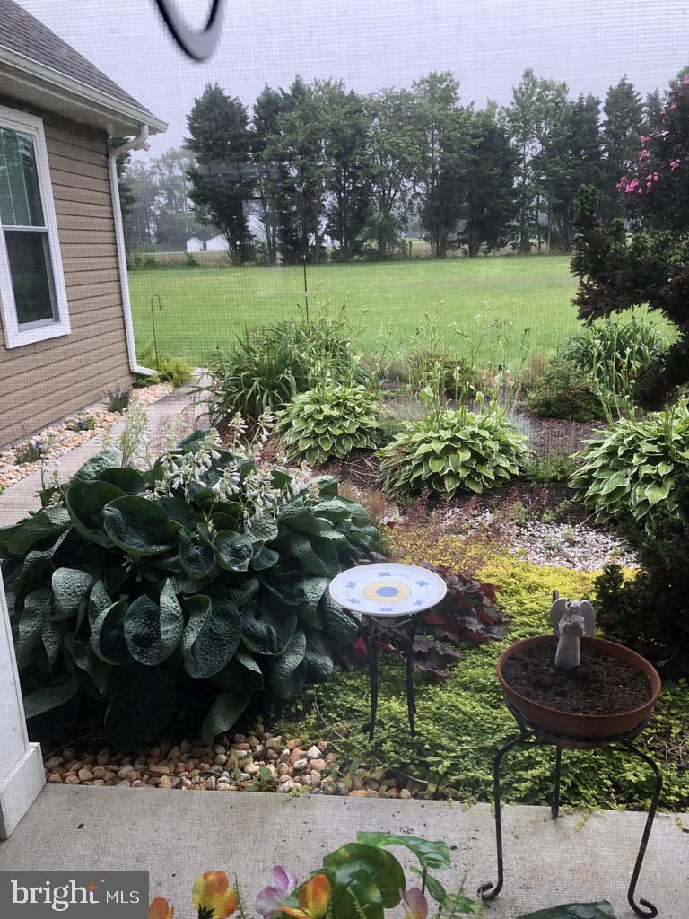 11910 Back Creek Road Bishopville, MD 21813 - Photo 67 of 94 a view of a backyard with table and chairs and potted plants