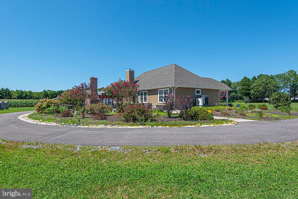 11910 Back Creek Road Bishopville, MD 21813 - Photo 83 of 94 a front view of a house with a yard and garage