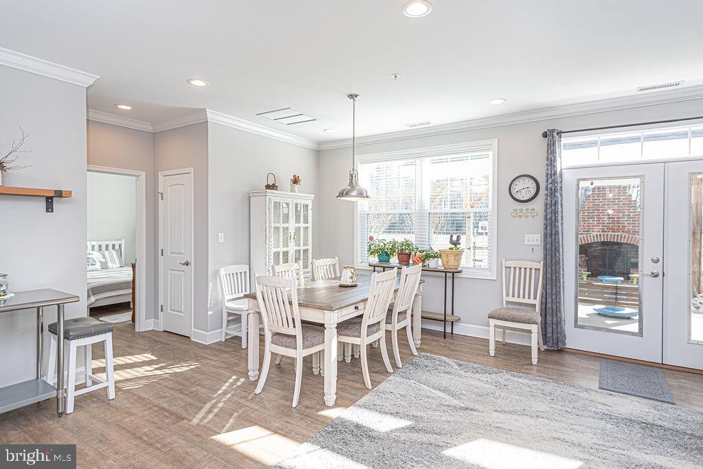 11910 Back Creek Road Bishopville, MD 21813 - Photo 10 of 94 a dining room with furniture a chandelier and wooden floor