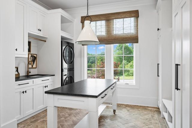 a view of hallway with microwave and cabinets