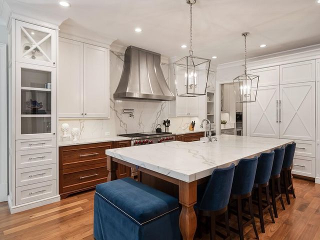 a kitchen with a table chairs sink and cabinets
