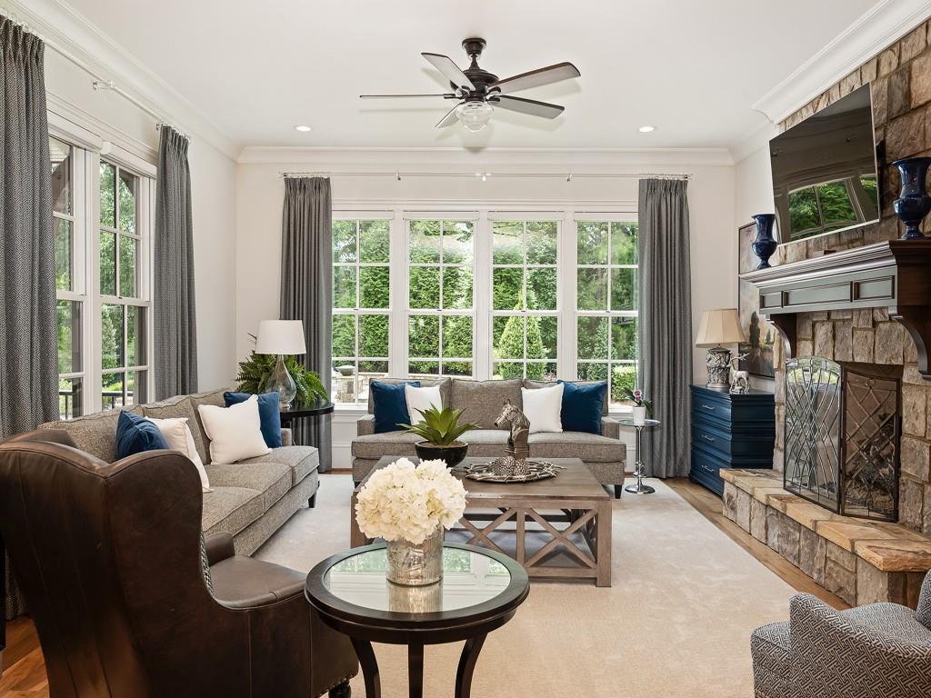 10155 Cedar Ridge Drive Milton, GA 30004 - Photo 38 of 44 a living room with furniture a fireplace and a flat screen tv