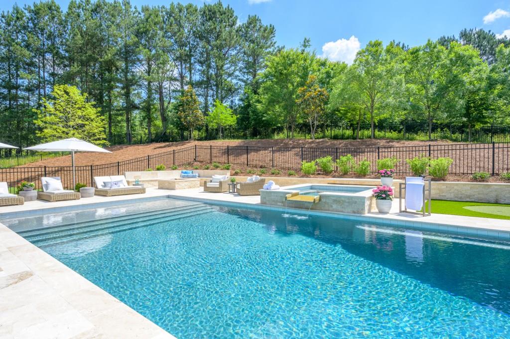 10155 Cedar Ridge Drive Milton, GA 30004 - Photo 7 of 44 a view of a swimming pool with a yard