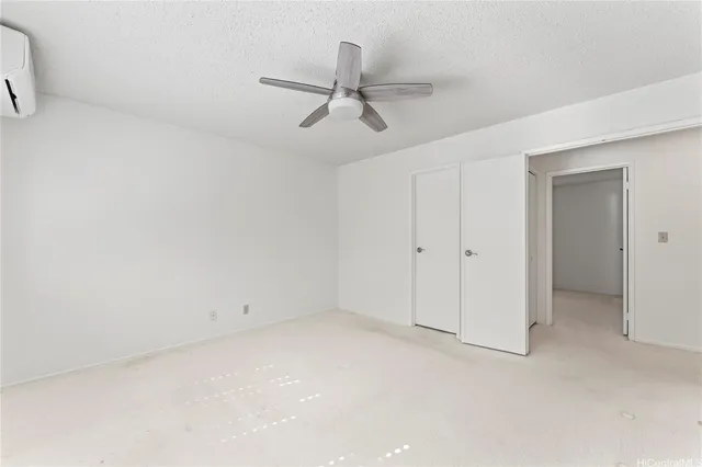 a bedroom with a bed and a potted plant