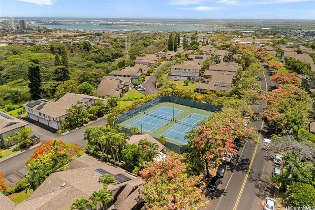 an aerial view of a house with garden space and street view