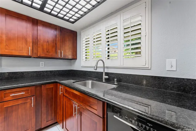 a kitchen with a stove a sink and a refrigerator