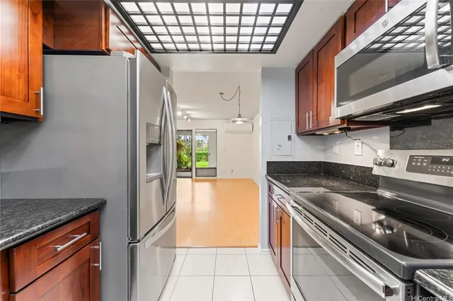 a kitchen with granite countertop a sink and a window