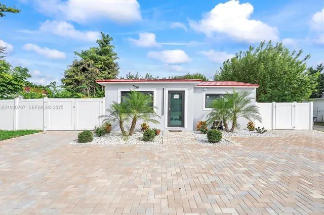 a view of a house with swimming pool and sitting area