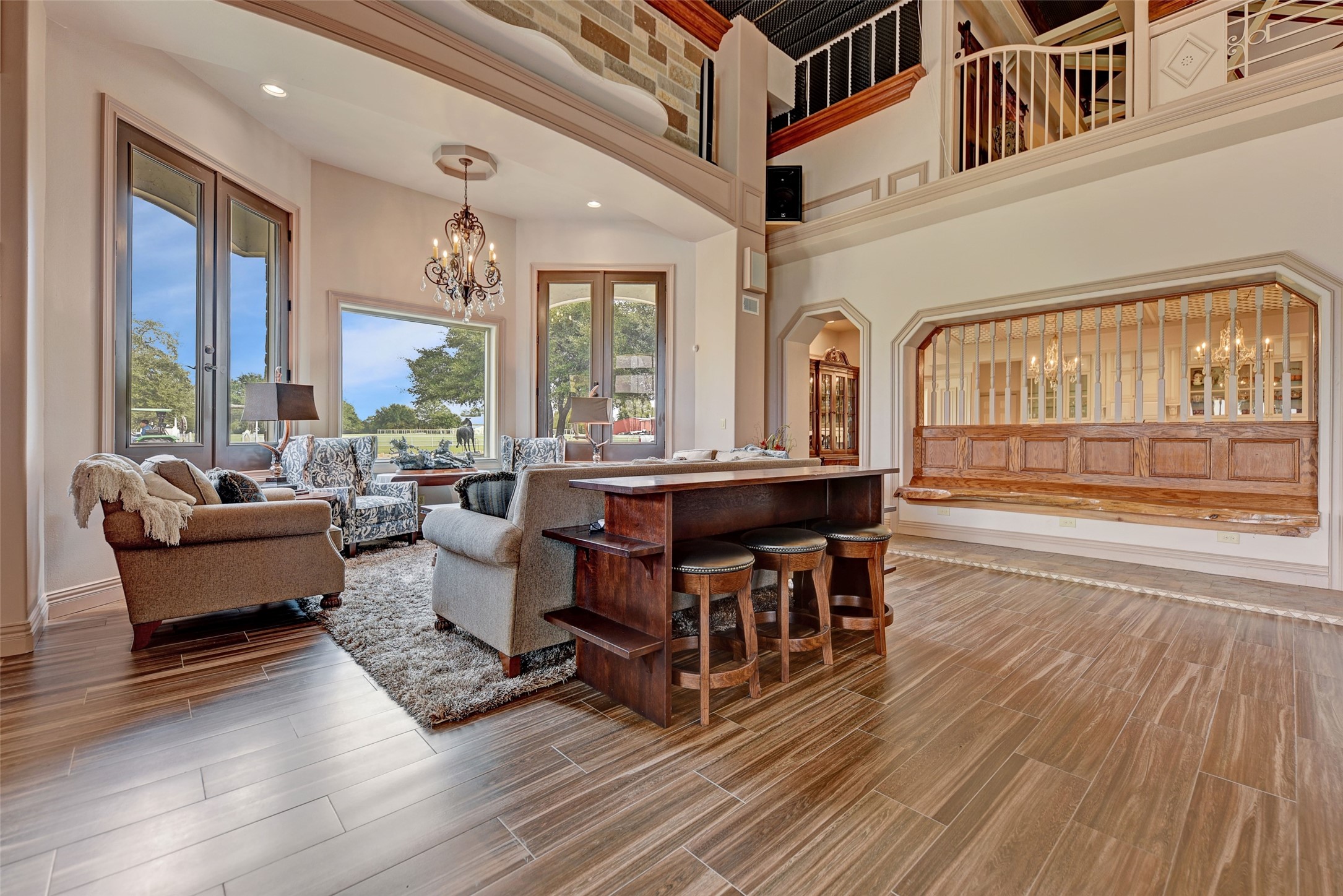 9950 Palestine Road Brenham, TX 77833 - Photo 11 of 49 Cannot beat the view from the spacious sitting area overlooking the frontline driveway and abundant landscaping. The built-in red oak and cypress wood benches bring a custom touch while providing extra seating space for your guests.