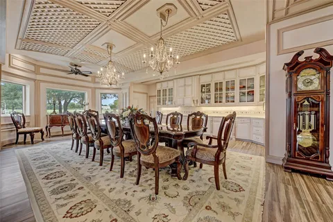 a living room with furniture a large window and wooden floor