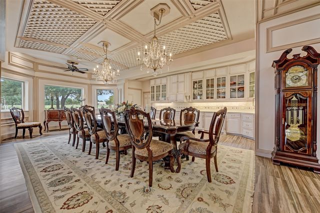 a living room with furniture a large window and wooden floor