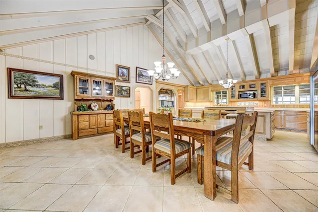 a view of a dining room with furniture and chandelier