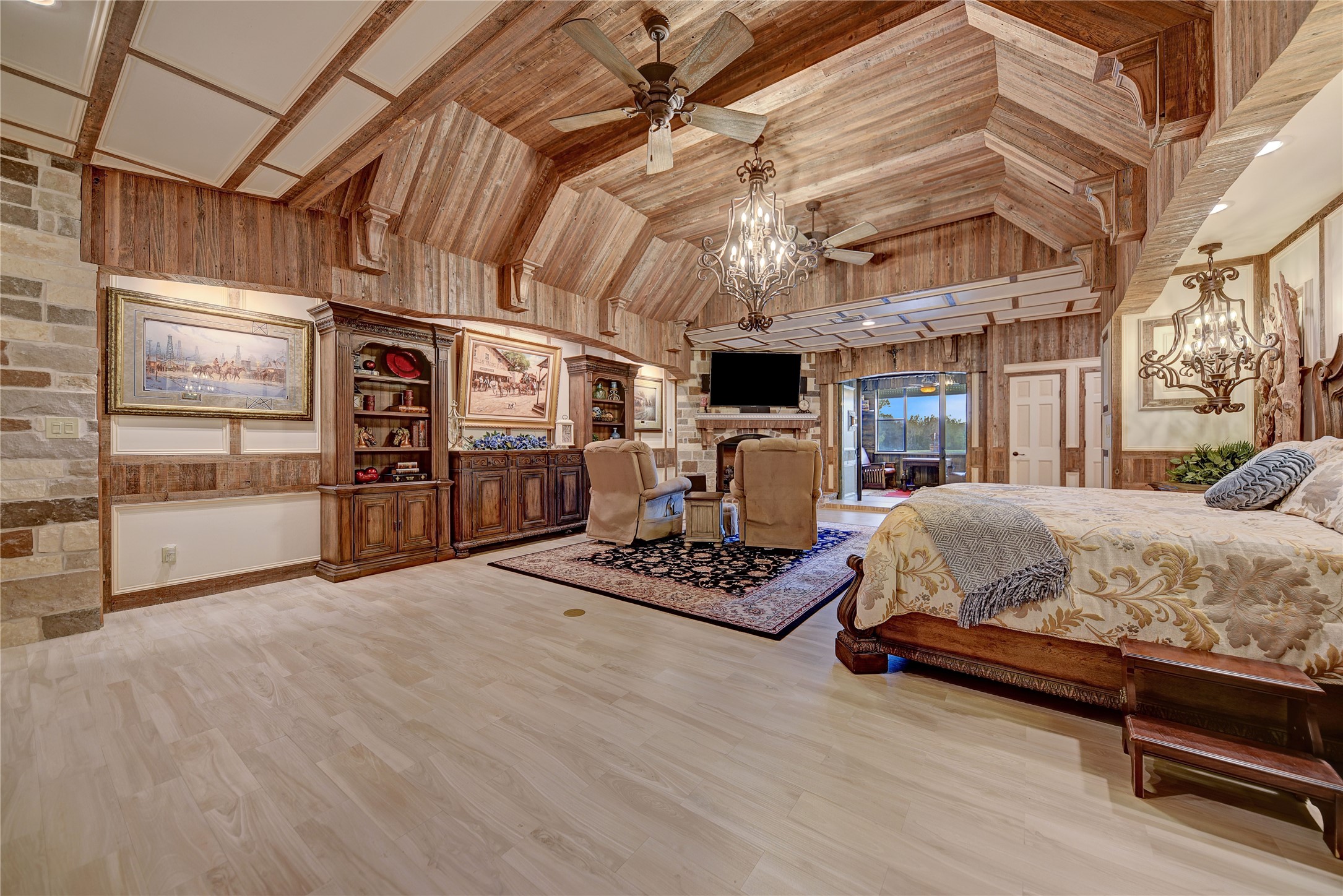 9950 Palestine Road Brenham, TX 77833 - Photo 15 of 49 The lavish primary suite 3,000+ SF primary suite includes the huge primary bedroom with extensive architectural detail throughout, two full bathrooms, one 1/2 bath, a kitchenette, a breakfast room, an exercise room with an endless workout pool, a walk-in safe, laundry room, and an indoor 44' sitting area with a wall of windows looking over the front 3.5-acre pond.