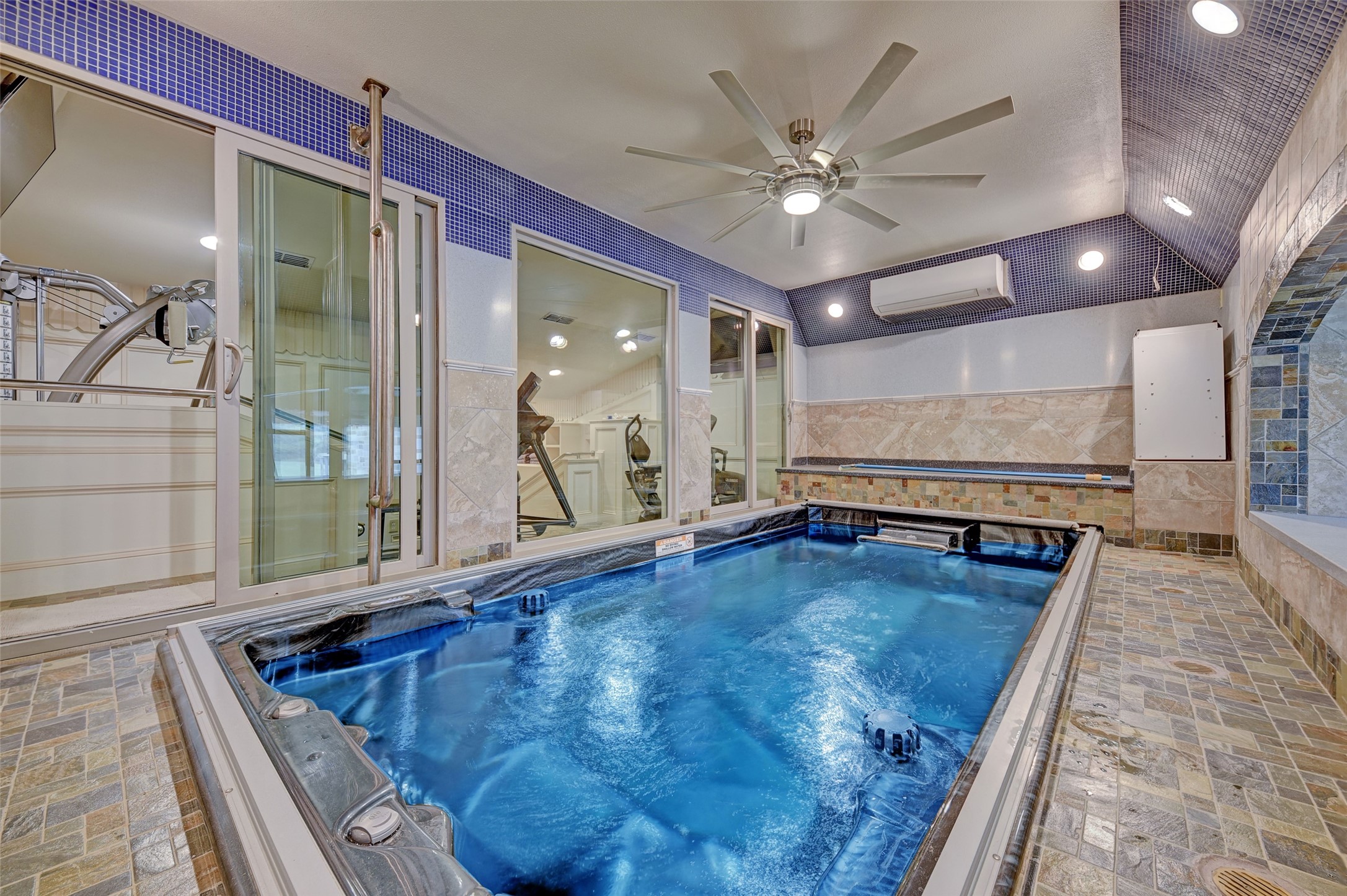 9950 Palestine Road Brenham, TX 77833 - Photo 19 of 49 The indoor Endless pool is located within the primary bedroom quarters and has a remote controlled underwater treadmill and swimmer.