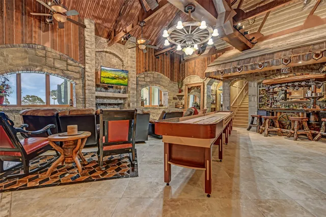 a backyard of a building with table and chairs