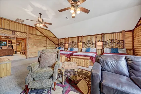 a living room with furniture a ceiling fan and a rug