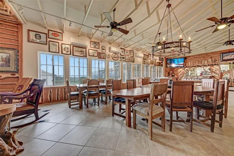 a view of a big dining room with furniture