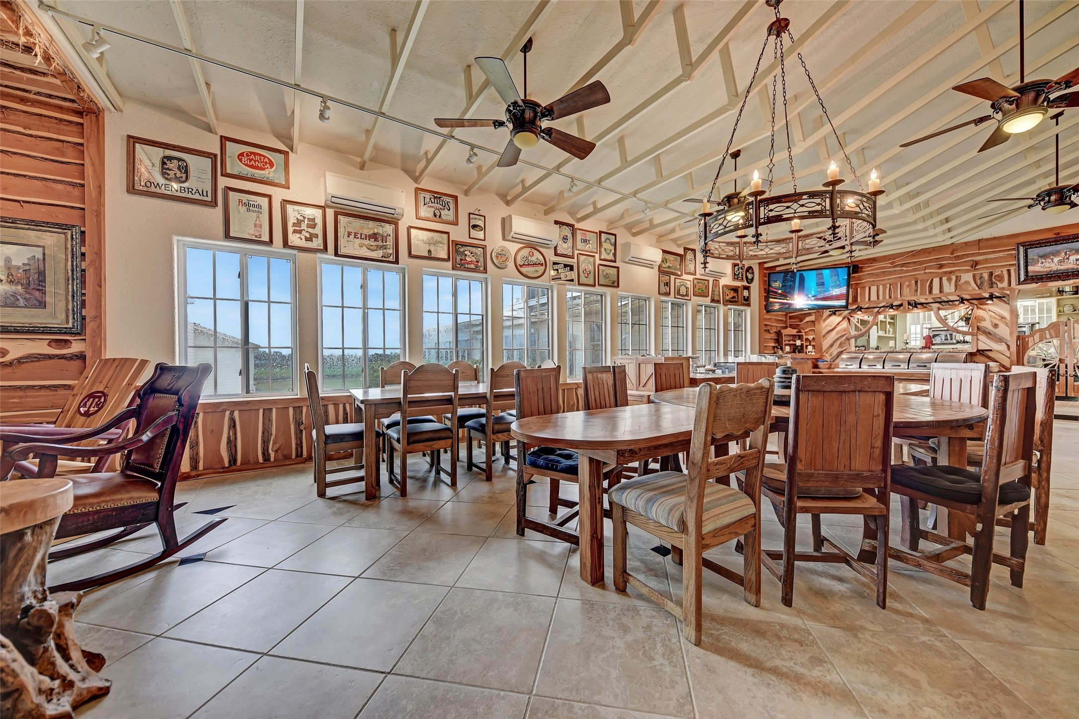 9950 Palestine Road Brenham, TX 77833 - Photo 32 of 49 This impressive 1,000+ SF commercial dining room has a built-in sound system hub and speakers, fireplace with floor to ceiling stone surround, floor to ceiling cedar walls, 5 ceiling fans, a wrought iron chandelier, floating rafters, and 4 wall mounted HVAC units in addition to the central A/C system.